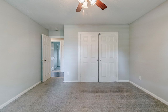 unfurnished bedroom with a closet, baseboards, and carpet flooring
