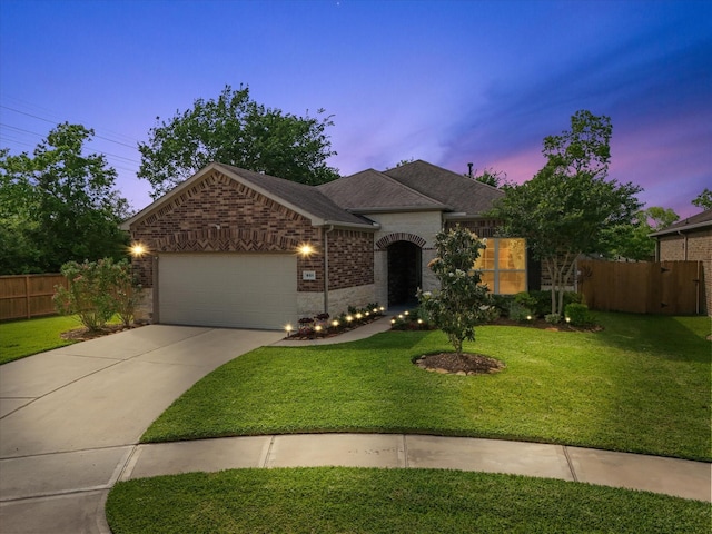 651 Tenuta Ln, League City, TX 77573 - single story home with concrete driveway, a front yard, an attached garage, and fence