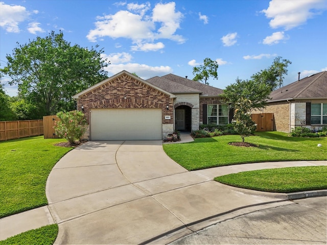 651 Tenuta Ln, League City, TX 77573 - single story home with brick siding, a front yard, concrete driveway, and a garage