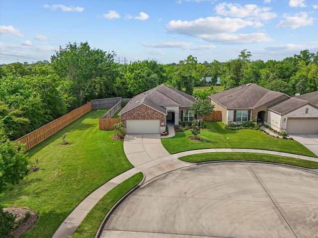 651 Tenuta Ln, League City, TX 77573 - exterior space featuring driveway, fence, brick siding, a front lawn, and a garage