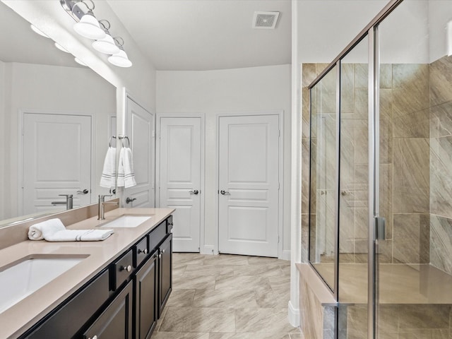 651 Tenuta Ln, League City, TX 77573 - full bathroom featuring visible vents, a shower stall, double vanity, and a sink