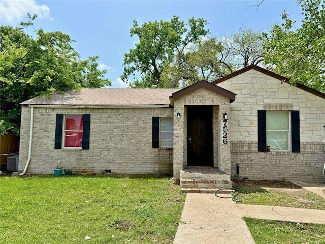 7526 Bywood St, Houston, TX 77028 - ranch-style house with a front lawn, brick siding, central AC unit, and a shingled roof