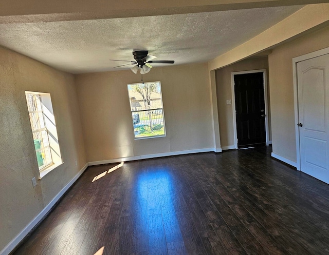 7526 Bywood St, Houston, TX 77028 - unfurnished room featuring plenty of natural light, a ceiling fan, a textured ceiling, and dark wood finished floors