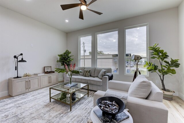 living room with recessed lighting, baseboards, a ceiling fan, and light wood-style flooring