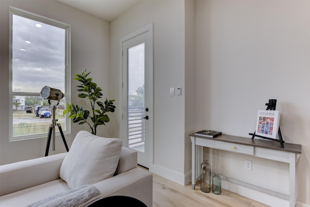 foyer featuring wood finished floors and baseboards