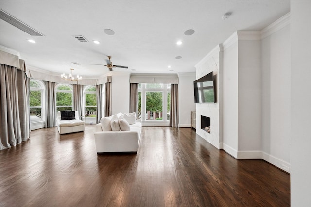 22 History Row, The Woodlands, TX 77380 - living area featuring a fireplace, dark wood finished floors, baseboards, ornamental molding, and visible vents