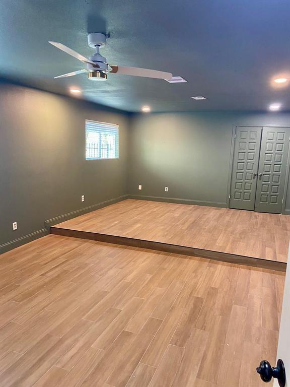 unfurnished room with baseboards, a ceiling fan, and wood finished floors