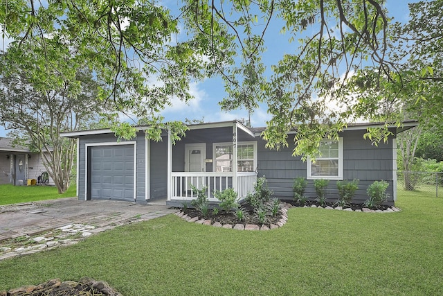 view of front of house with fence, a garage, a front yard, covered porch, and driveway