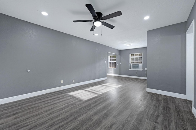 unfurnished living room with cooling unit, a ceiling fan, baseboards, recessed lighting, and dark wood-type flooring