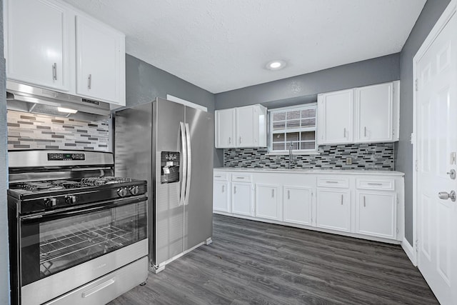 kitchen featuring under cabinet range hood, stainless steel appliances, white cabinets, and dark wood-style floors
