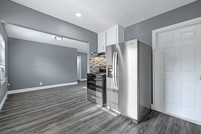 kitchen featuring white cabinets, stainless steel appliances, baseboards, and dark wood finished floors