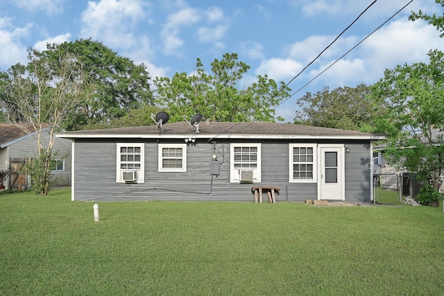 back of property featuring fence and a yard