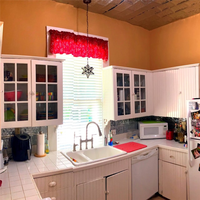 504 Gay Hill St, Brenham, TX 77833 - kitchen featuring tile patterned floors, a sink, white appliances, glass insert cabinets, and decorative light fixtures