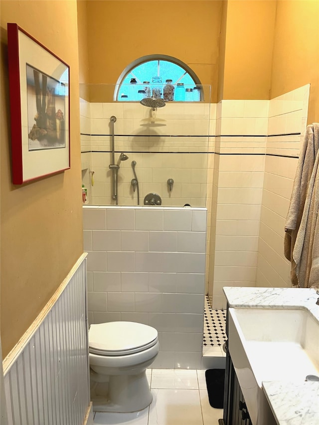 504 Gay Hill St, Brenham, TX 77833 - bathroom with tiled shower, wainscoting, toilet, tile patterned flooring, and vanity