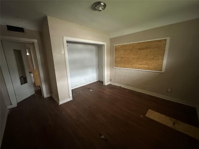 2038 Norfolk St Unit A, Houston, TX 77098 - unfurnished bedroom with baseboards, visible vents, wood finished floors, and a closet