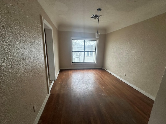 2038 Norfolk St Unit A, Houston, TX 77098 - spare room with baseboards, a textured wall, wood finished floors, and visible vents