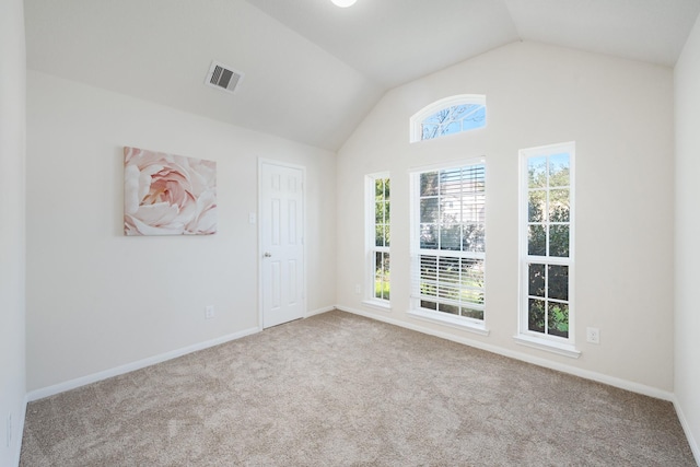 unfurnished room with baseboards, vaulted ceiling, visible vents, and carpet floors