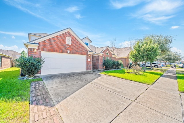 traditional-style house with an attached garage, brick siding, driveway, and a front yard