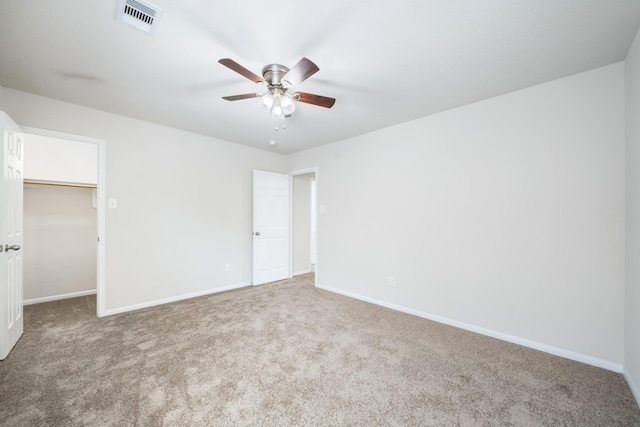 unfurnished bedroom featuring baseboards, carpet flooring, and visible vents