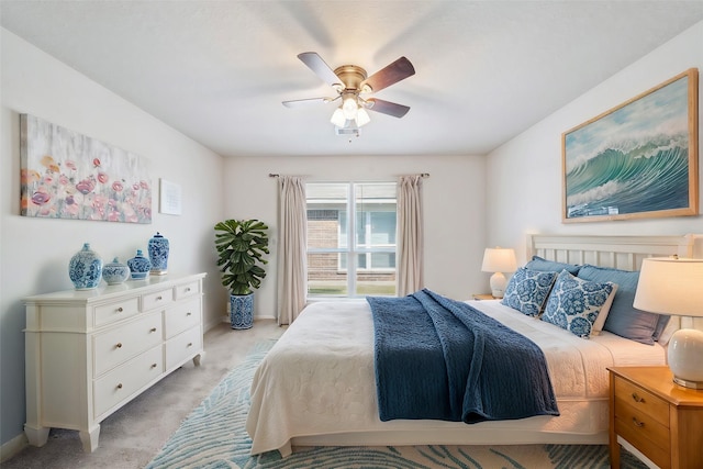 bedroom with a ceiling fan and light colored carpet