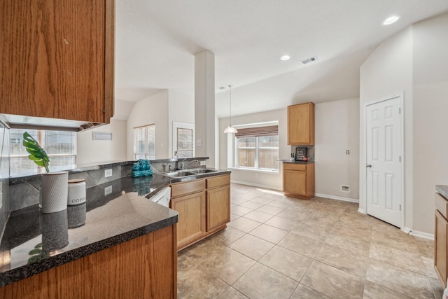 kitchen with a sink, light tile patterned flooring, pendant lighting, lofted ceiling, and visible vents
