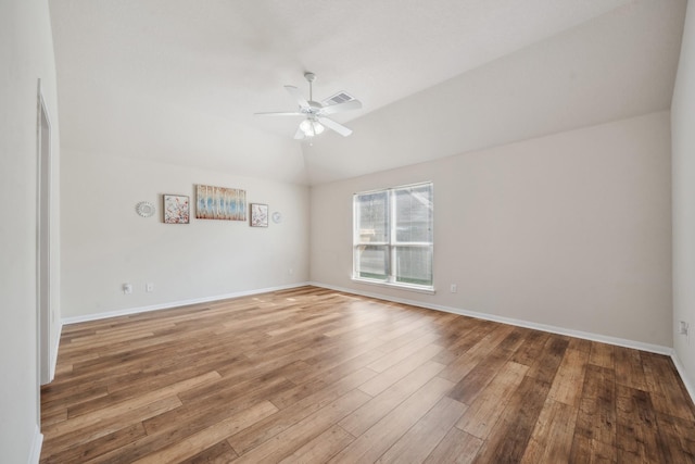 empty room with light wood-type flooring, vaulted ceiling, baseboards, visible vents, and a ceiling fan