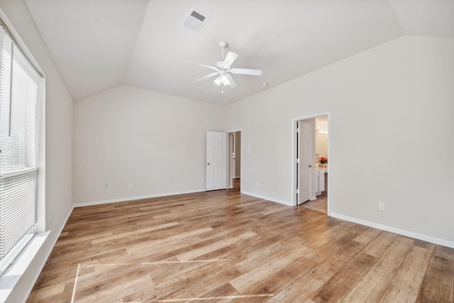 unfurnished bedroom with vaulted ceiling, visible vents, and light wood-style floors