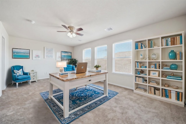 office space featuring visible vents, a ceiling fan, baseboards, and carpet floors