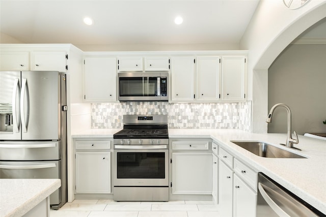 29 Clara Barton Ln, Galveston, TX 77551 - kitchen featuring white cabinets, appliances with stainless steel finishes, a sink, recessed lighting, and decorative backsplash