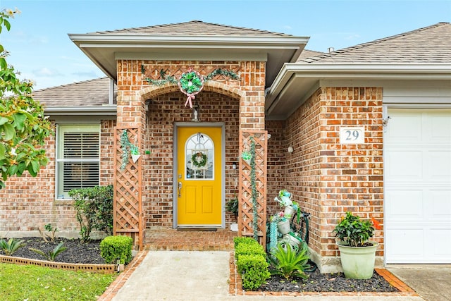 29 Clara Barton Ln, Galveston, TX 77551 - entrance to property featuring brick siding, a shingled roof, and a garage