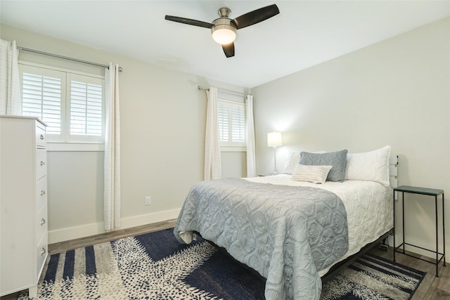 29 Clara Barton Ln, Galveston, TX 77551 - bedroom featuring ceiling fan, baseboards, multiple windows, and wood finished floors