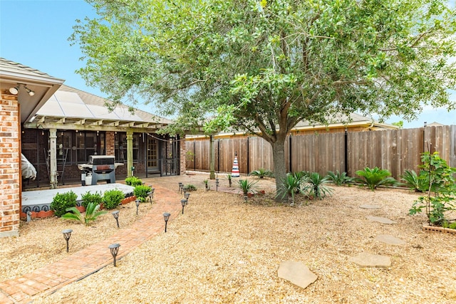 29 Clara Barton Ln, Galveston, TX 77551 - view of yard featuring a sunroom, a fenced backyard, and a patio
