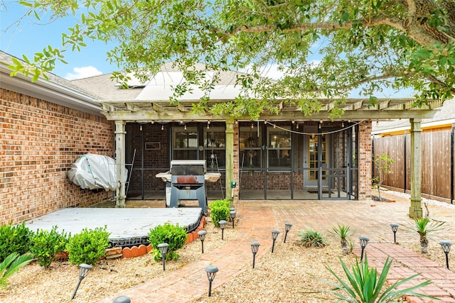 29 Clara Barton Ln, Galveston, TX 77551 - back of house with fence, a deck, french doors, brick siding, and a hot tub