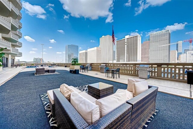 view of patio featuring an outdoor living space, a view of city, and area for grilling