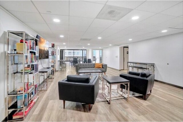 living area with recessed lighting, wood finished floors, and baseboards