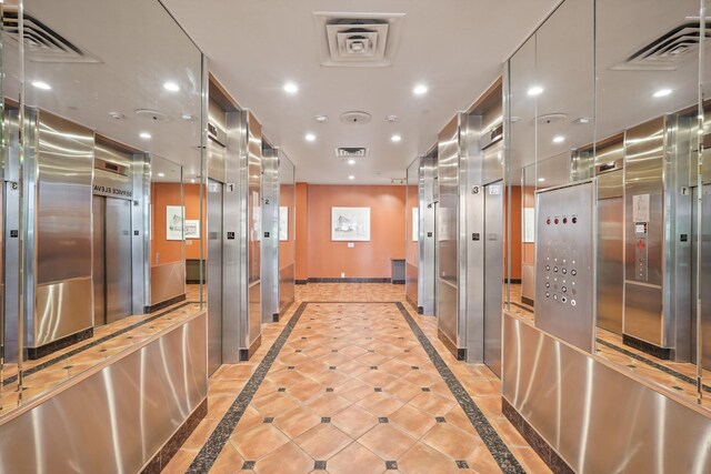 corridor featuring recessed lighting, visible vents, and baseboards
