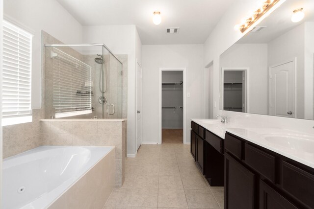 full bathroom with a sink, a stall shower, visible vents, a jetted tub, and tile patterned flooring