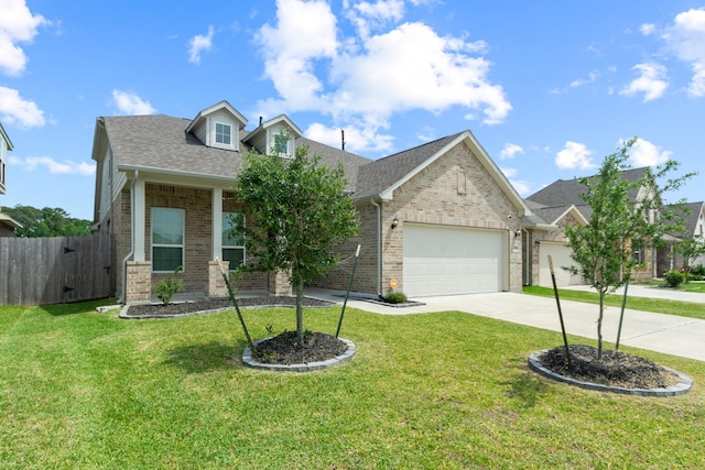 view of front of property with driveway, an attached garage, fence, a front yard, and brick siding