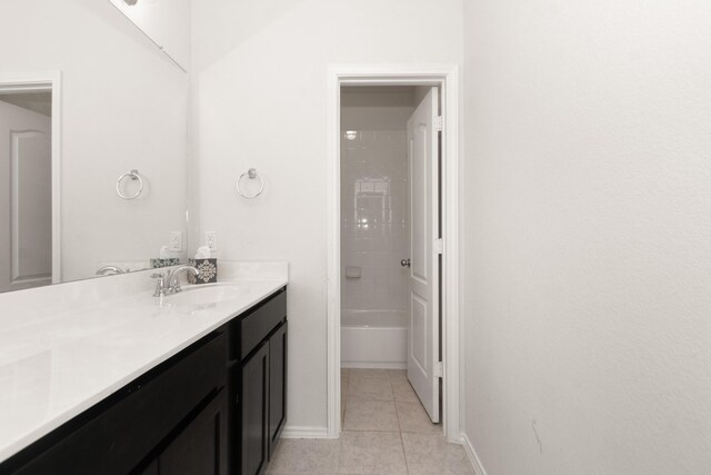 bathroom featuring vanity, baseboards, and tile patterned flooring