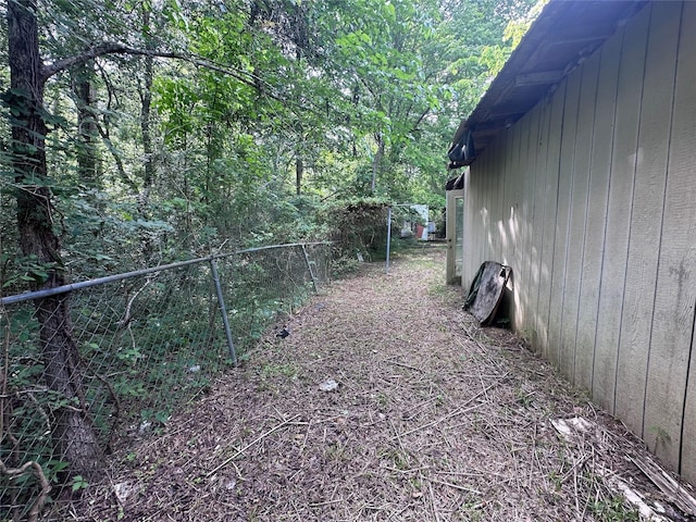 217 Box Factory Rd, Diboll, TX 75941 - view of home's exterior with a forest view and fence