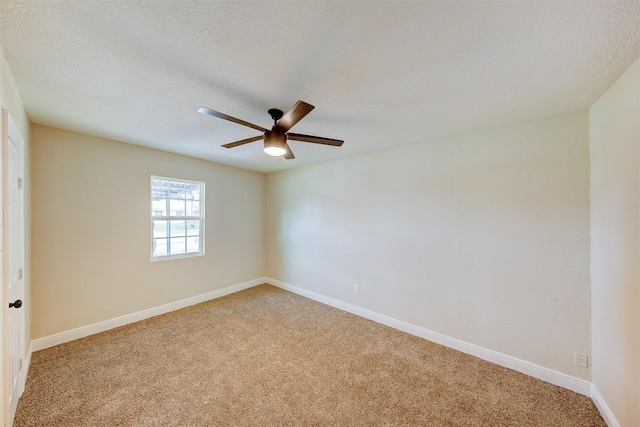 unfurnished room featuring ceiling fan, a textured ceiling, baseboards, and light carpet