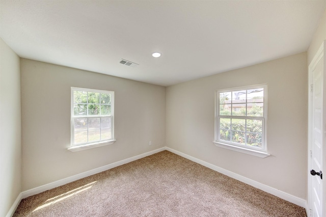 carpeted spare room with recessed lighting, visible vents, and baseboards