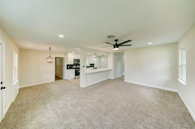 unfurnished living room featuring light carpet, baseboards, visible vents, and ceiling fan