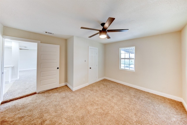 unfurnished bedroom with visible vents, baseboards, carpet, and a closet