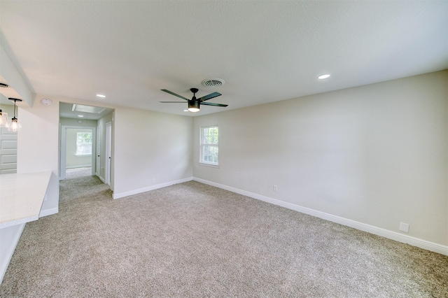 unfurnished room with attic access, light carpet, visible vents, recessed lighting, and a ceiling fan