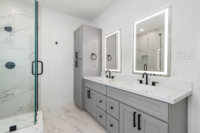 full bath featuring marble finish floor, a marble finish shower, and a sink