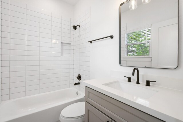 full bath with vanity, shower / tub combination, and toilet
