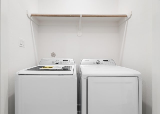 laundry room with separate washer and dryer and laundry area