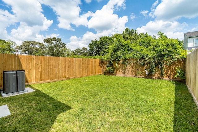 view of yard featuring a fenced backyard and cooling unit
