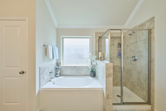 bathroom with ornamental molding, a stall shower, and a bath